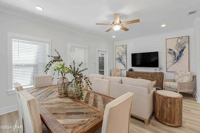 dining area featuring light wood-type flooring, ceiling fan, visible vents, and crown molding