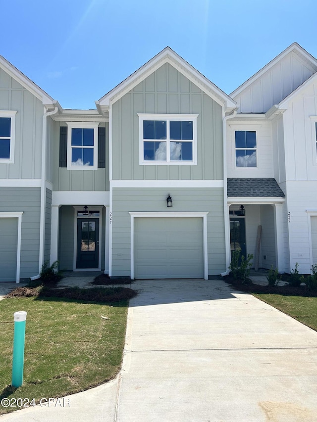 view of front facade featuring board and batten siding, concrete driveway, roof with shingles, and an attached garage