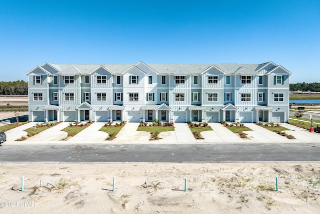 townhome / multi-family property with driveway, board and batten siding, and a residential view