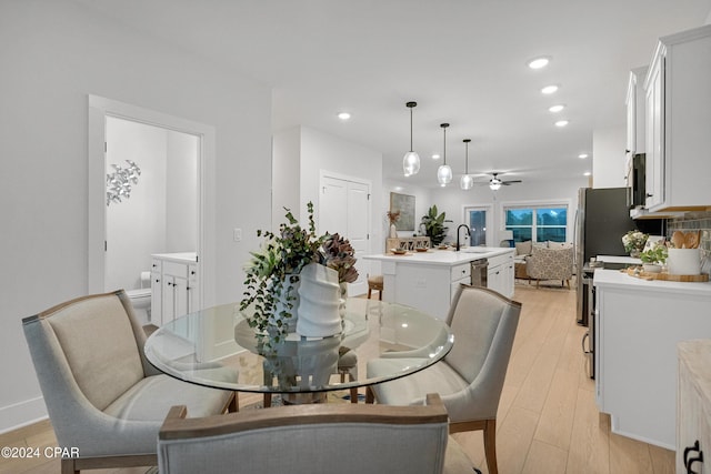 dining area with light wood-type flooring, a ceiling fan, and recessed lighting