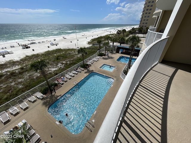 community pool featuring view of water and beach