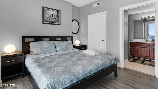 bedroom with wood finished floors and baseboards