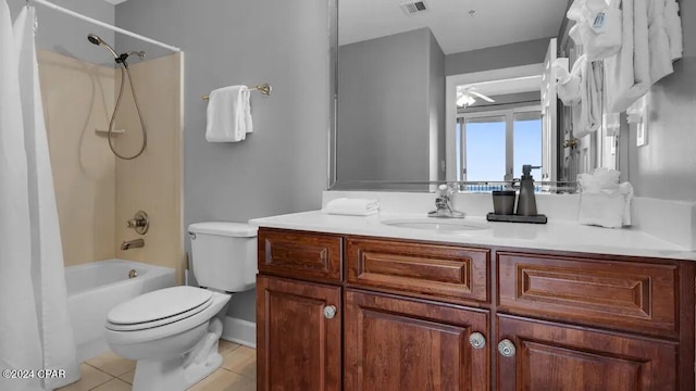 bathroom with tile patterned floors, toilet, vanity, and shower / bath combination with curtain