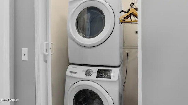 clothes washing area with estacked washer and dryer