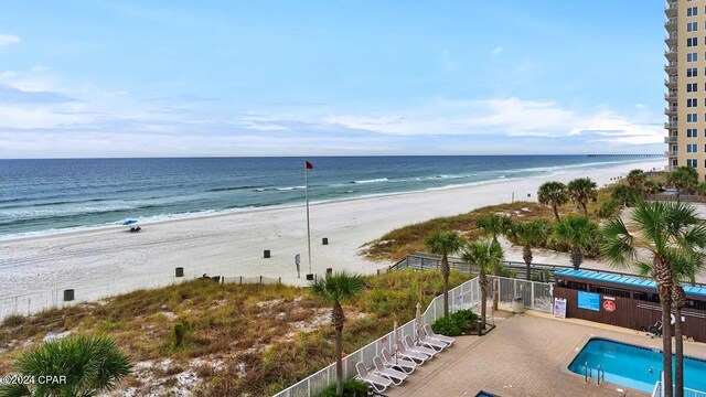 water view with nearby beach and fence