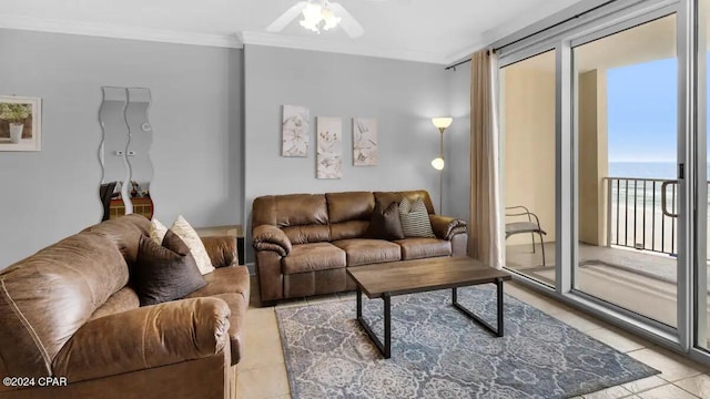 living room featuring light tile patterned floors, crown molding, and a ceiling fan