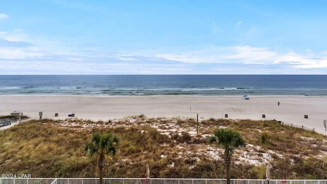 water view with nearby beach and fence