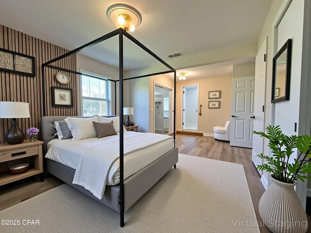 bedroom featuring visible vents, wood finished floors, and baseboards