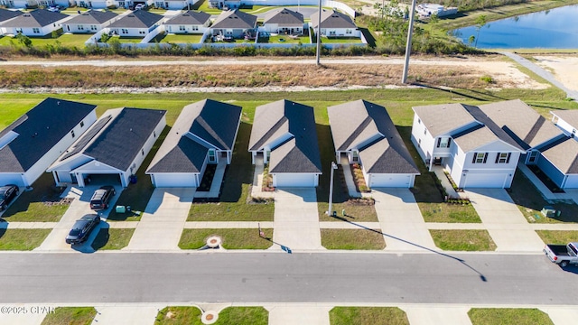 aerial view featuring a residential view and a water view