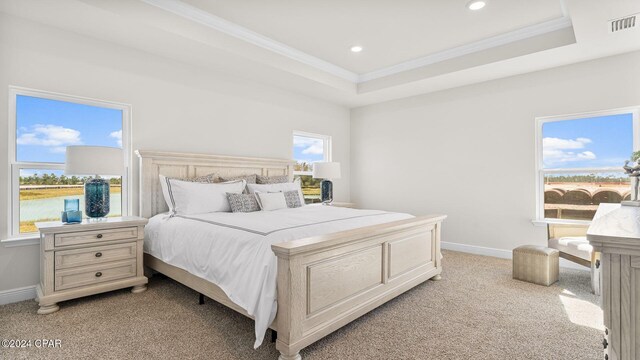 bedroom with light carpet, visible vents, baseboards, a raised ceiling, and crown molding