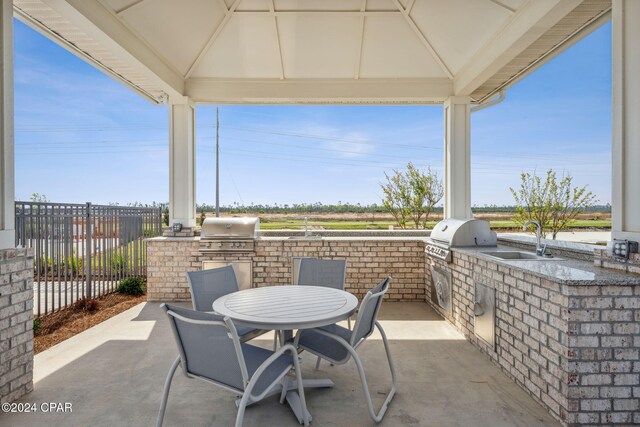 view of patio / terrace featuring a gazebo, a sink, and area for grilling