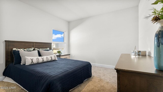 carpeted bedroom featuring baseboards