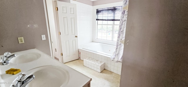 bathroom featuring double vanity, tiled tub, a sink, and a shower with shower curtain