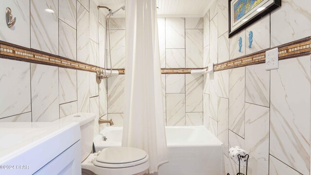 14401 Front Beach Rd Unit 432, Panama City Beach, FL 32413 - full bathroom with shower / bath combo with shower curtain, toilet, vanity, and tile walls