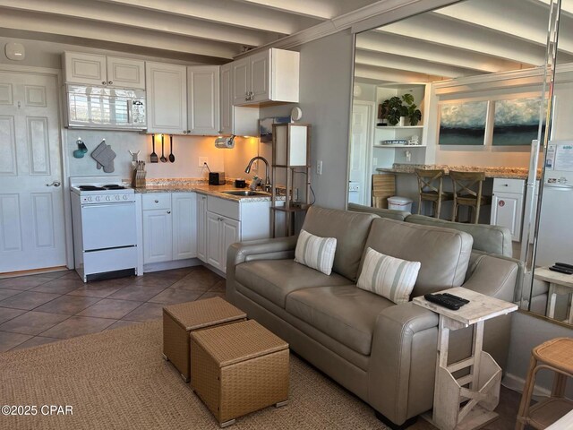 14401 Front Beach Rd Unit 432, Panama City Beach, FL 32413 - living room with tile patterned floors and beamed ceiling