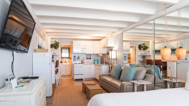 14401 Front Beach Rd Unit 432, Panama City Beach, FL 32413 - bedroom with beamed ceiling, a sink, and freestanding refrigerator