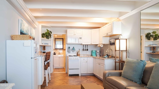 14401 Front Beach Rd Unit 432, Panama City Beach, FL 32413 - kitchen with light tile patterned floors, a sink, white cabinetry, and white appliances