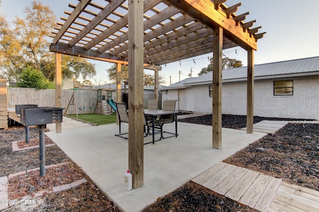 view of patio / terrace featuring a playground, fence, and a pergola