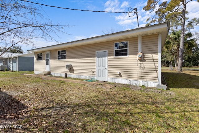 back of property featuring central AC unit and a lawn