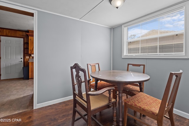 dining room with baseboards and dark wood finished floors