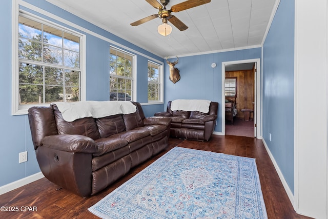 living room featuring ornamental molding, ceiling fan, baseboards, and wood finished floors