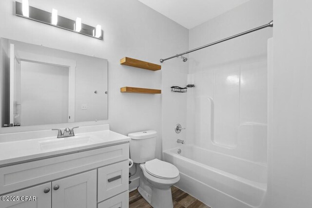 full bathroom featuring vanity, tub / shower combination, wood finished floors, and toilet