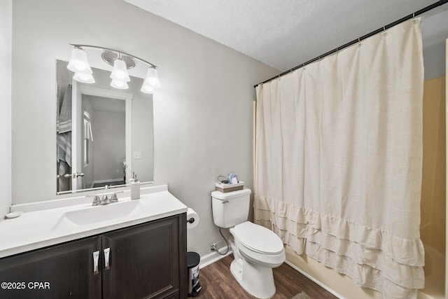 full bathroom featuring shower / bath combo, toilet, wood finished floors, a textured ceiling, and vanity