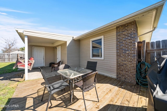 deck featuring fence and outdoor dining space