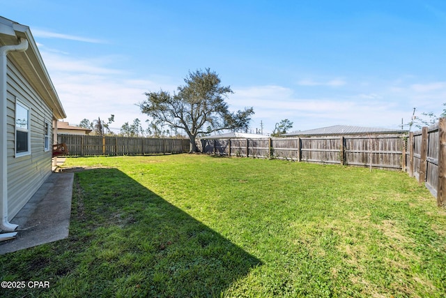 view of yard with a fenced backyard