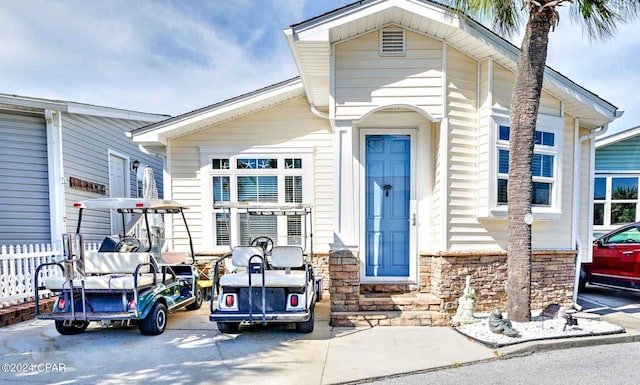 317 Lagoon Ln, Panama City Beach, FL 32408 - view of front of property featuring stone siding and fence