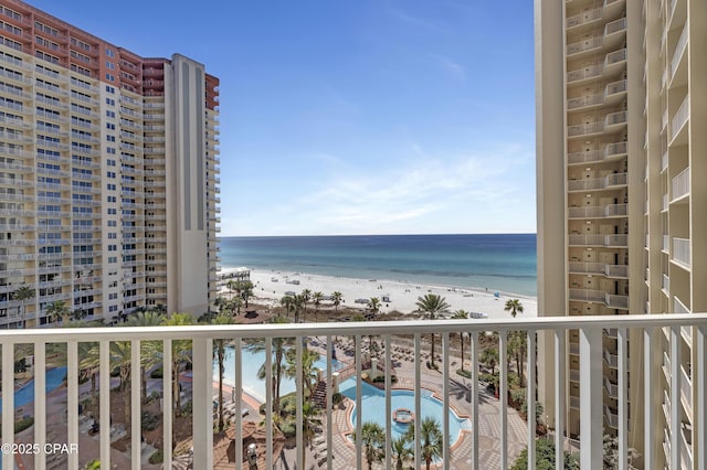 balcony featuring a beach view and a water view