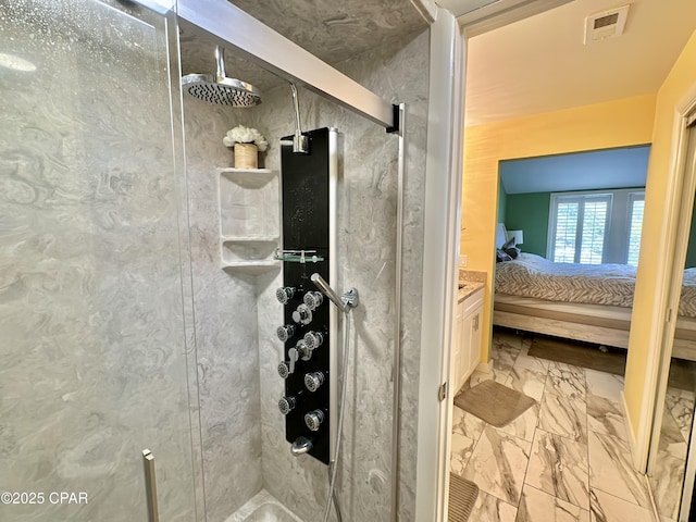 ensuite bathroom featuring visible vents, marble finish floor, ensuite bathroom, and a stall shower