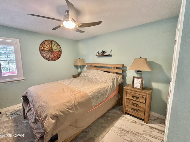 bedroom with baseboards, marble finish floor, and ceiling fan