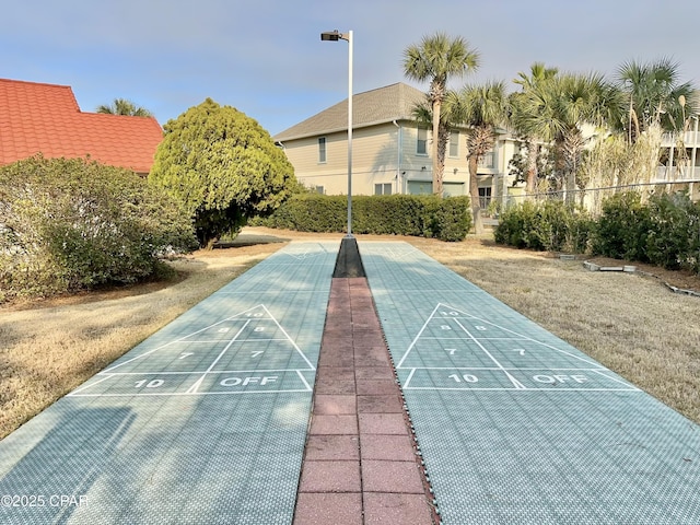 view of property's community featuring shuffleboard