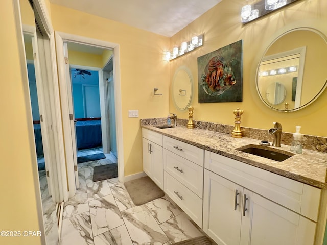 ensuite bathroom featuring ensuite bath, double vanity, marble finish floor, and a sink