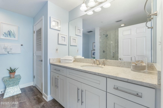 12011 Front Beach Rd Unit 204B, Panama City Beach, FL 32407 - full bath featuring a shower stall, vanity, wood finished floors, baseboards, and a closet