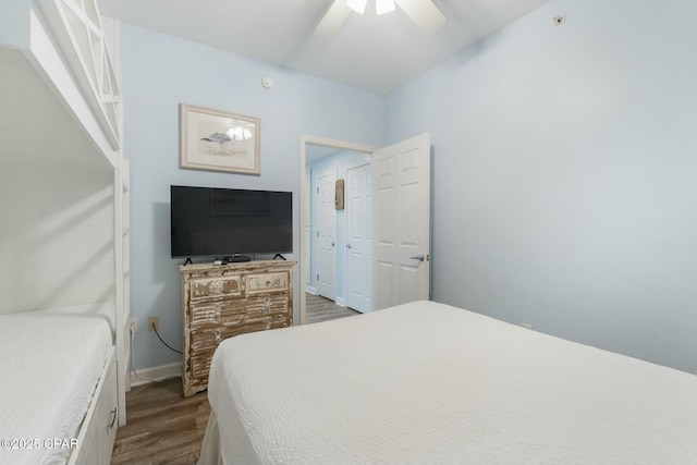 12011 Front Beach Rd Unit 204B, Panama City Beach, FL 32407 - bedroom with dark wood-style floors, ceiling fan, and baseboards
