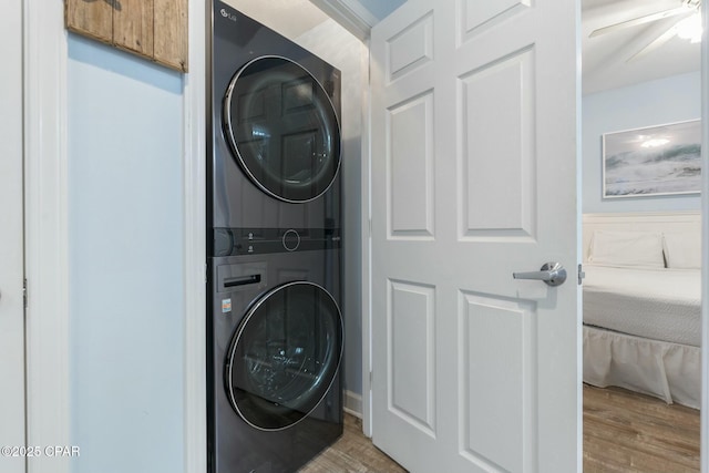 12011 Front Beach Rd Unit 204B, Panama City Beach, FL 32407 - laundry room with stacked washer and clothes dryer, wood finished floors, and a ceiling fan