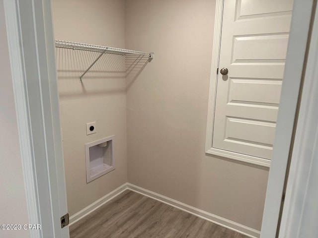 washroom featuring laundry area, wood finished floors, electric dryer hookup, and baseboards