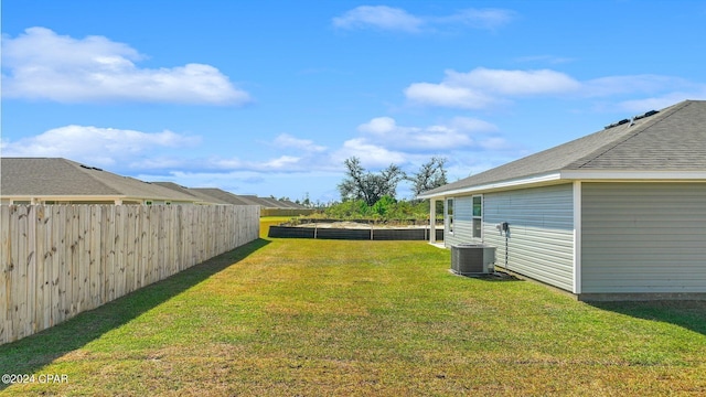 view of yard featuring fence and cooling unit