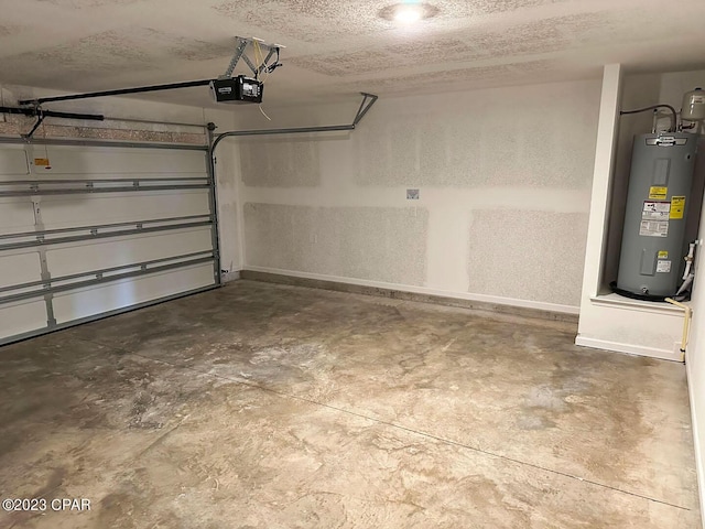 garage featuring baseboards, electric water heater, and a garage door opener