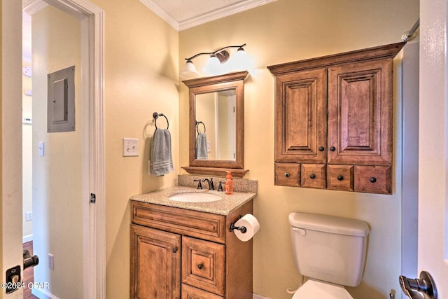 bathroom featuring toilet, ornamental molding, vanity, and electric panel