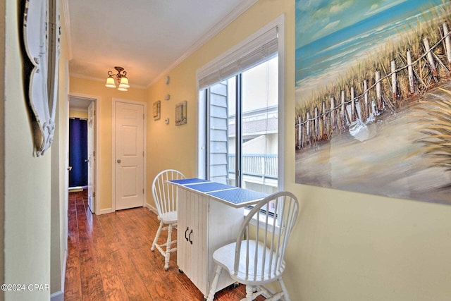 dining area with ornamental molding, wood finished floors, and baseboards