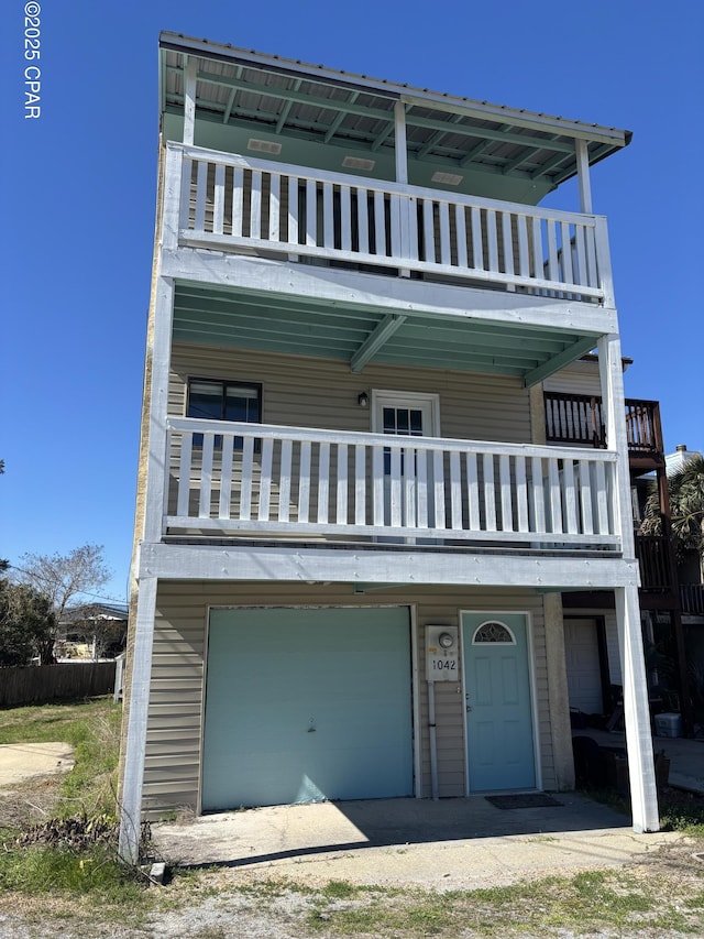 view of front of house featuring a garage and a balcony