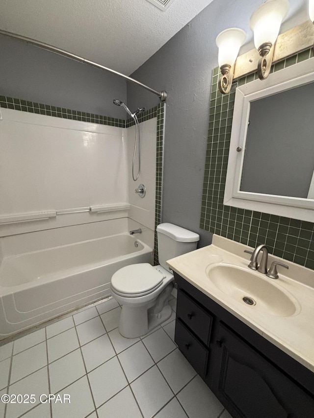 bathroom with shower / bathing tub combination, toilet, a textured ceiling, vanity, and tile patterned flooring