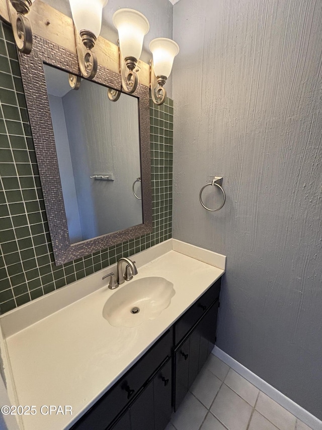 bathroom with tile patterned flooring, vanity, and baseboards