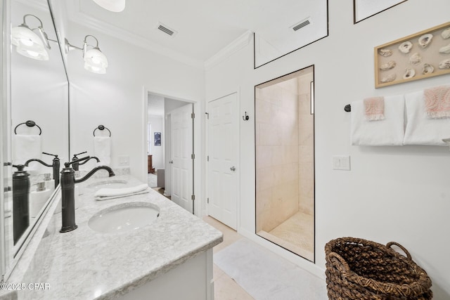 full bath with visible vents, ornamental molding, a sink, a tile shower, and double vanity