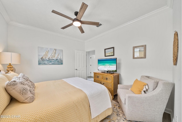 bedroom featuring visible vents, crown molding, and a ceiling fan