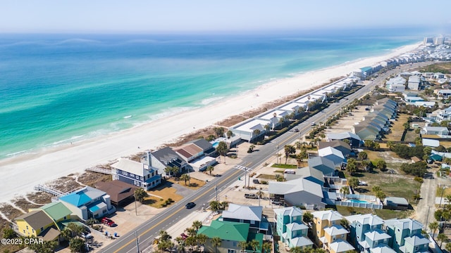 drone / aerial view with a residential view, a beach view, and a water view