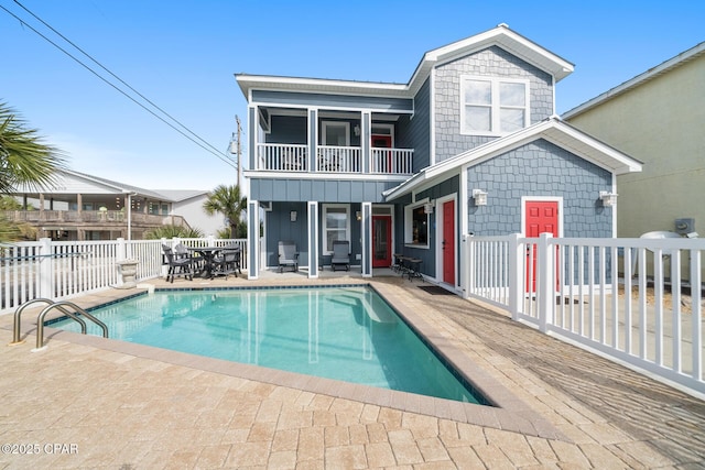 exterior space featuring outdoor dining space, a fenced in pool, a patio, and fence